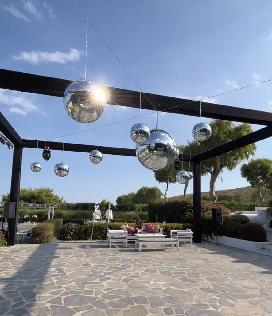Disco balls over an outdoor wedding dance floor