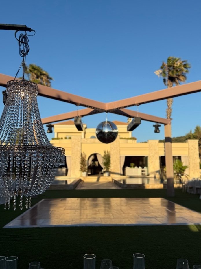 Chandelier and disco ball over a garden dance floor